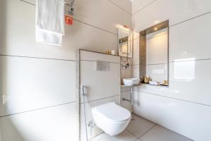 a white bathroom with a toilet and a shower at The Munshi Mansion in Jodhpur