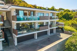 an aerial view of a large house with balconies at Kaiteriteri Luxury Apartment in Kaiteriteri