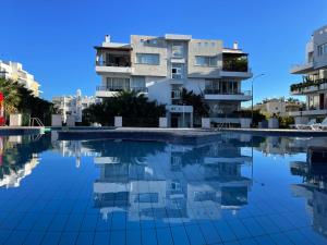 a swimming pool with buildings in the background at RIX Apartments in Kyrenia