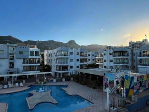 a large apartment complex with a swimming pool and buildings at RIX Apartments in Kyrenia
