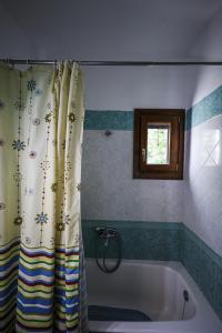 een bad met een douchegordijn in de badkamer bij Asano's House in Agios Nikolaos +51 foto's