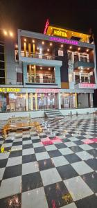 a building with a checkered floor in front at Hotel Sanjay palace in Mahwah