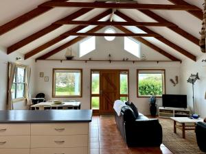 a living room with a ceiling with exposed beams at Dunes Blue at Robe in Robe
