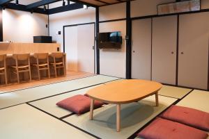 a room with a table and chairs and a counter at Authentic Kyoto Machiya Sleeps 7 Near Station in Fushimi