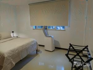 a bedroom with a bed and a window and a trash can at Apartamento Amplio Cerca de Todo con Seguridad y con Todas las Comodidades de un Hospedaje Renovado y Totalmente Equipado, ademas Tene Wi-Fi de Alta Velocidad in Caracas