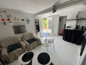a living room with a couch and a table at la cachette bas in Salies-de-Béarn
