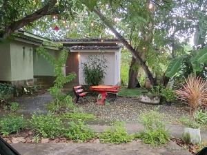 a picnic table and a bench in a garden at Oasis Pai Resort in Pai