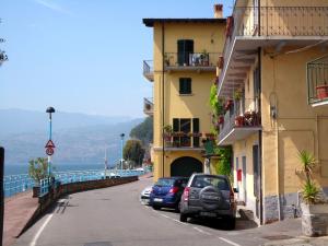 a street with cars parked on the side of a building at Apartment in Vello by Lake Iseo Beach in Marone