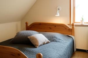 a bedroom with a bed with a pillow on it at Strandhuset i Øster Hurup in Øster Hurup