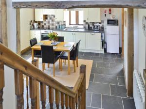 a kitchen and dining room with a table and chairs at Bramble in Hartland
