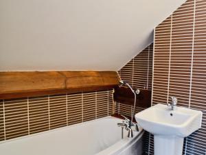 a bathroom with a sink and a bath tub at Fenn House in Alvechurch +4 photos