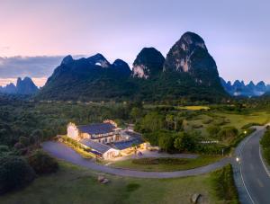 an aerial view of a resort with mountains in the background at Moonlit Cloud Inn Yangshuo Yulong River in Yangshuo