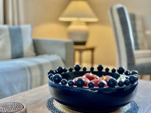 a bowl of fruit sitting on a table at Gilbertson Cottage in Wheldrake +46 photos