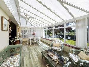 a living room with a conservatory with a ceiling at Broadoak Barn in Ellesmere