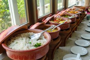 a row of bowls of rice on a table at Six Elements Beach Villa in Tangalle
