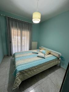 a bedroom with a bed in a room with a window at Diamond Stay in Kilkís