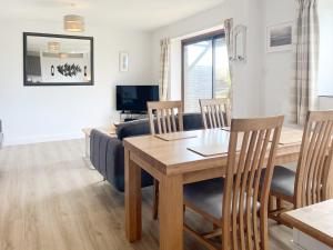 a living room with a table and a couch at Harvest Cottage in Padstow