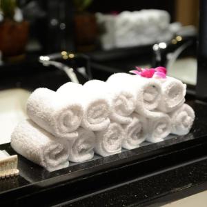 a pile of towels sitting on top of a sink at Hoan Kiem Old Quarter Hotel Alley 22 Hang Voi in Hanoi