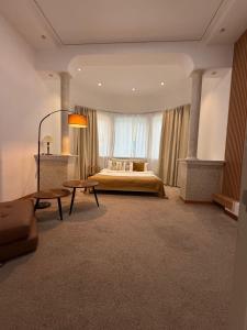 a large bedroom with a bed and a window at shymbulak gateway homestay in Almaty