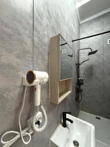 a bathroom with a shower and a white sink at shymbulak gateway homestay in Almaty +74 photos