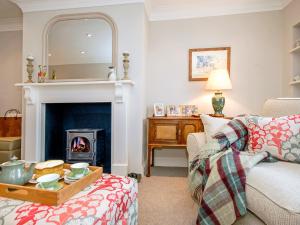 a living room with a fireplace and a couch at Haven View in Neyland