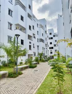 an exterior view of a white building at Alvy 2bedroom apartment in Mombasa
