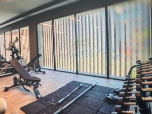 a gym with treadmills and exercise equipment in front of windows at Cyprus Sunbay Retreat in Ayia Napa