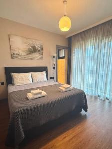 a bedroom with a bed with two towels on it at Cyprus Sunbay Retreat in Ayia Napa +4 photos