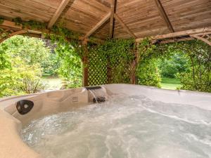 a jacuzzi tub under a wooden roof at Mountain View in Llawhaden