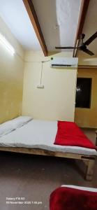 a bedroom with a bed with a red blanket at Divya ganga hotel in Varanasi +10 photos