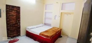 a small bedroom with a bed and a window at Divya ganga hotel in Varanasi