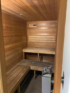 a sauna with a bench in a room at Cozy 1 Bed Apartment - 2 Min to Queen VIC Market in Melbourne
