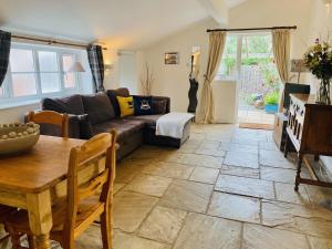 a living room with a couch and a table at The Parlour in Earls Croome