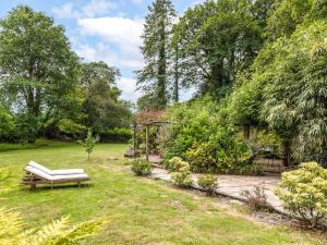 a garden with a bench in the grass at Mountain View in Llawhaden