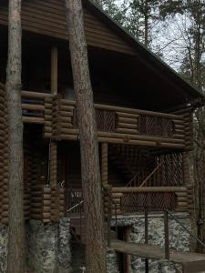 a log cabin in the woods with trees at Готельно-ресторанний комплекс Загадка in Khmelʼnytsʼkyy