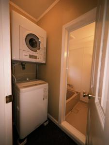 a small bathroom with a refrigerator and a microwave at やまぽっちYamapochi Cottage in Hakuba +76 photos
