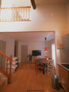 a kitchen and living room with a table and a dining room at やまぽっちYamapochi Cottage in Hakuba