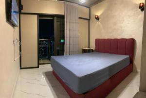 a bedroom with a bed and a red couch at Aqaren Apartment in Amman