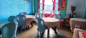 a row of tables and chairs in a room at Chander Pahar Retreat in Kalimpong