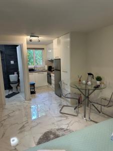 a kitchen with a table and a sink and a counter at JOHNMAR apartment in Athens