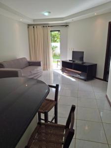 a living room with a couch and a table at Ocean View Tabatinga Residence in Barra de Tabatinga