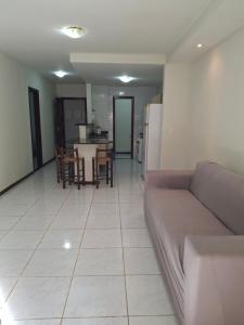 a living room and kitchen with a couch and a table at Ocean View Tabatinga Residence in Barra de Tabatinga