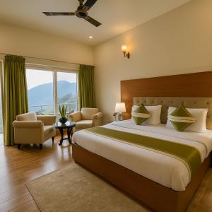 a bedroom with a large bed and a large window at The Kempty Emerald - A Wellness Boutique Hotel, Mussoorie in Mussoorie