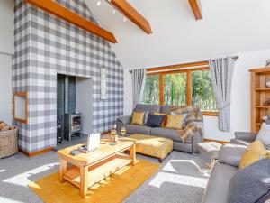 a living room with a couch and a table at Sunnyside House in Duthil