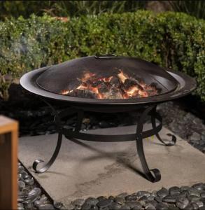 a grill with a fire inside of it at Woy Woy Staycation - Heated Pool & Hot Tub & BBQ & Pizza Oven & Arcade Game & Pool Table in Woy Woy