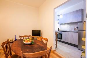 a kitchen with a table with a bowl of fruit on it at Casa Sofia in Cannobio