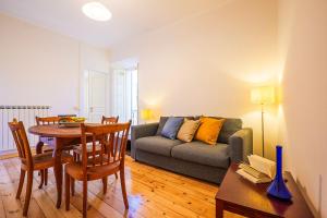 a living room with a table and a couch at Casa Sofia in Cannobio