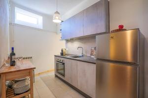 a kitchen with a stainless steel refrigerator and a table at Casa Sofia in Cannobio