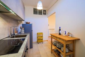 a kitchen with a table and a blue refrigerator at Casa Sofia in Cannobio