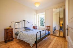 a bedroom with a bed and a wooden floor at Casa Sofia in Cannobio +24 photos
